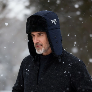 Navy blue winter trapper hat with black faux fur lining and ear flaps for extreme cold weather