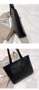 Detailed view of black tote bag with quilted diamond pattern and smooth PU leather