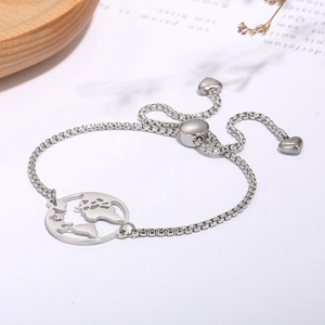 Detail of adjustable silver map bracelet with globe charm and sliding heart clasp