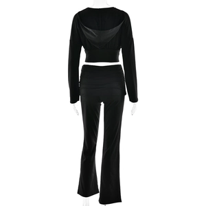 Rear view of black cropped hoodie and high-waisted flared sweatpants two-piece set