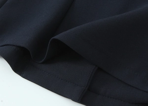 Close-up of navy blue high-density twill fabric showing fine stitching and texture