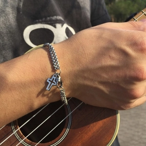 Men's double-layer stainless steel bracelet with cross pendant and braided chain on wrist