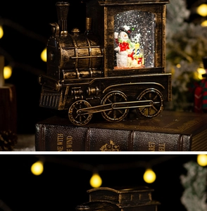 Macro shot of bronze vintage train snow globe with snowman and festive glitter interior