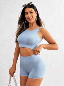 Detail of light blue ribbed seamless knit workout crop top and high waist fitness shorts