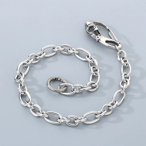 Detail of silver skull clasp and textured round buckle on steel heavy pants chain
