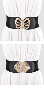Close-up of gold metal buckle with rhinestones on a black elastic waist belt