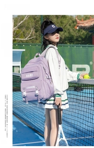 Detail of purple utility backpack with Hard Learning text and buckle details