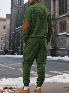 Outdoor back view of men's green knit tracksuit with rhombus texture and elbow patches