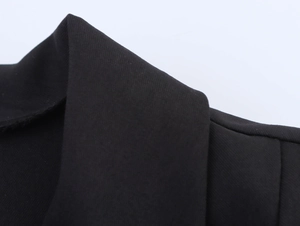Close-up of black woven fabric texture with twill pattern on women's vest collar