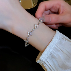Detail of a silver flower bracelet with sparkling zircons on a model wrist