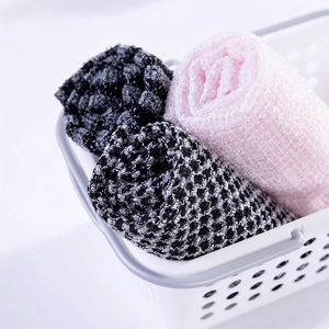 Three rolls of double-sided exfoliating body scrub towels in black, grey and pink