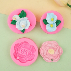 Macro detail of 3D rose silicone molds and finished floral plaster crafts for DIY