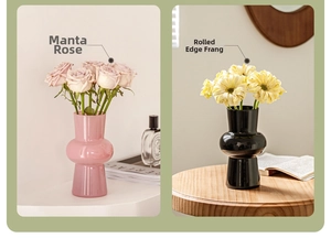 Detail view of pink and black modern glass vases in a stylish tabletop setting
