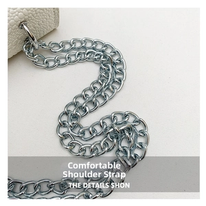 Detail of elegant silver metal chain strap on premium white textured leather shoulder bag