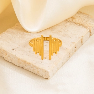 Detailed close-up of 18K gold-plated irregular ring on stone and beige silk fabric