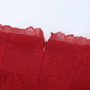 Macro shot of invisible zipper on the neckline of a red lace off-shoulder dress