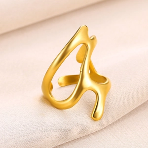 Detailed view of 18k gold plated stainless steel irregular multilayer ring on beige fabric