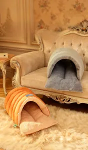Detail of semi-enclosed tunnel pet bed with plush lining in orange and grey colors