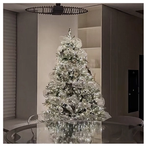 Close-up of elegant Christmas tree decorated with silver-white ribbon and warm LED lights