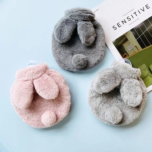 Three plush rabbit ear hot water bottle covers in pink and grey on a blue background