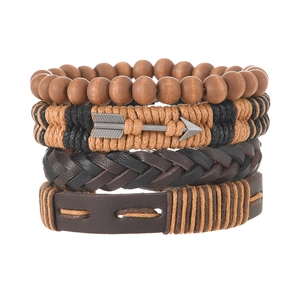 Detail of four-piece retro braided bracelet set with leather, wood beads, and metal arrow