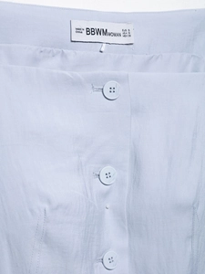 Close-up of light blue vest neckline showing three buttons and size S brand label