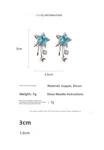 Detail view of silver star earrings with zircons measuring 3cm by 1.6cm dimensions