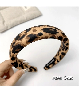 Close-up of handmade leopard print headband showing the 3cm width and inner lining detail