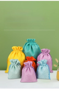 Detailed texture of colorful linen drawstring pouches for jewelry and gift packaging