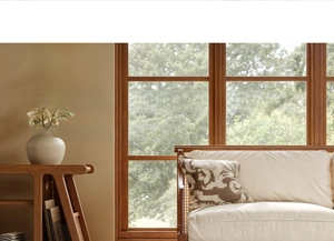 Detail view of modern living room furniture with wooden side table and textile sofa