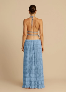 Detailed back view of light blue halter top and tiered ruffle skirt with pleated fabric
