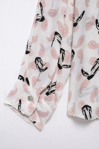 Detail of vintage paisley print shirt cuff with button on lightweight fabric