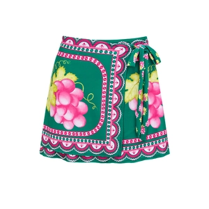 Detail of green wrap skirt with grape print and wavy trim for beachwear
