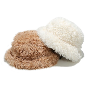 Detailed texture of fuzzy faux fur bucket hats in beige and light brown for winter warmth