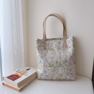Floral cotton tote bag with brown leather handles and pink flower patterns for women