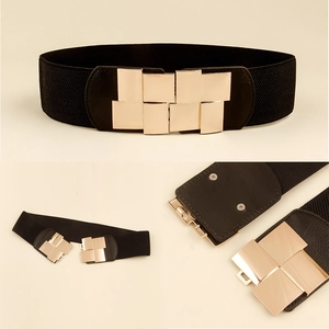 Detail of black elastic waist belt featuring interlocking gold geometric metal buckle closure