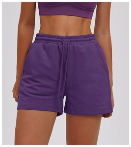 Close-up of purple sports shorts with elastic waistband and adjustable drawstring