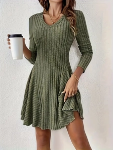 Detail of elegant olive green V-neck knitted mini dress with long sleeves and ribbed texture