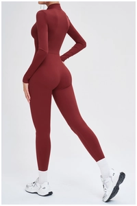 Detail of burgundy long sleeve thermal bodysuit showing slim fit yoga jumpsuit texture