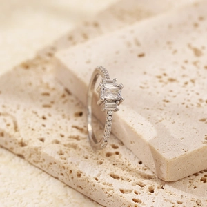 Macro detail of S925 silver ring with emerald-cut zircon and pavé setting on stone