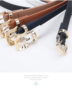 Detail of five colored thin leather belts with polished golden metal buckles in macro view