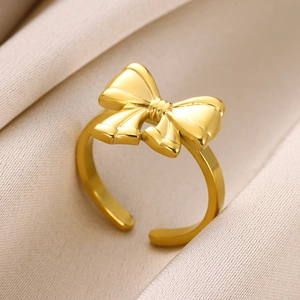 Elegant gold bow-shaped open ring for women with polished finish on champagne silk