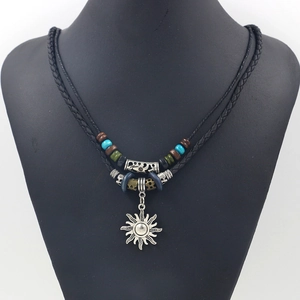 Bohemian sun pendant necklace with multilayered black woven rope and colorful wood beads