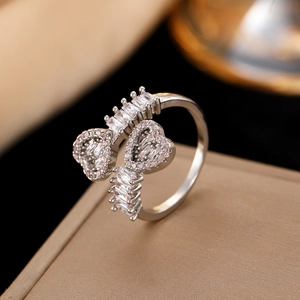 Close-up of heart-shaped ring with cubic zirconia on a luxury beige jewelry box