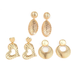 Three pairs of gold textured earrings featuring oval, heart, and sunburst geometric designs