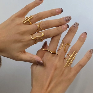 Set of minimalist irregular gold rings with geometric and wavy lines for women