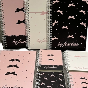 Pink bow spiral A5 notebook with polka dots and be fearless text on the cover