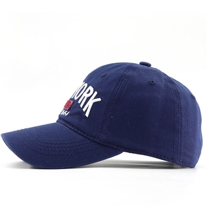 Detail of navy cotton baseball cap showing white 3D embroidery and decorative 1664 patch