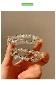 Detailed close-up of premium sparkling crystal hair clips with elegant gold finish plating