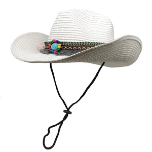 Detail of white straw cowboy hat with ethnic beads, turquoise stone and grey tassel decor